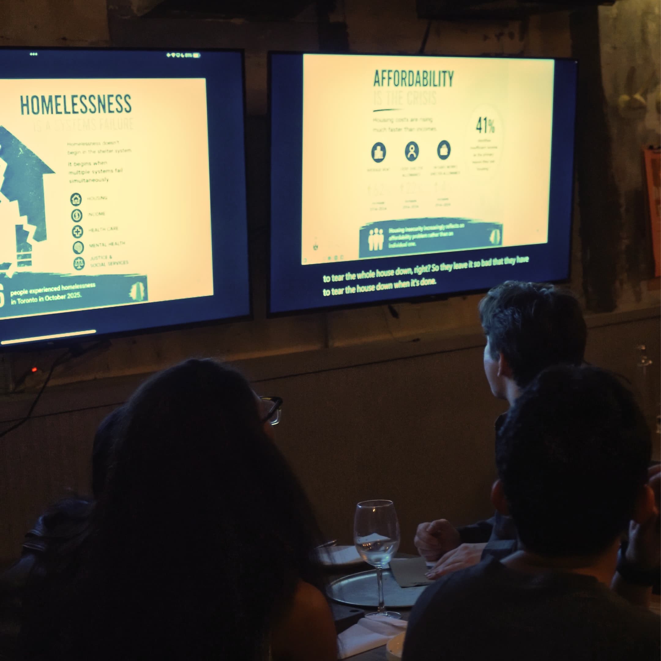 Attendees watching a Talks Over Draft presentation